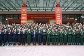 Party General Secretary To Lam (ninth, left, front row) and delegates at the meeting pose for a group photo. (Photo: VNA)
