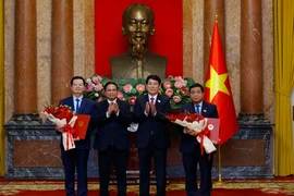 From left: State President Luong Cuong (3nd) and Prime Minister Pham Minh Chinh (2nd) congratulate the new Deputy PMs Mai Van Chinh (1st) and Nguyen Chi Dung. (Photo: VNA)