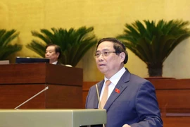 Prime Minister Pham Minh Chinh presents a report on results of socio-economic development for 2025 and the last five years, along with projections for 2026 at the opening ceremony of the 15th National Assembly's 10th session on October 20, 2025. (Photo: VNA)