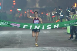 Nguyen Thi Oanh crosses the finish line in a new national record time for the women's 21km category in the Vietnam International Half Marathon 2025 powered by Herbalife on January 1 in Hanoi. (Photo: VIHM)