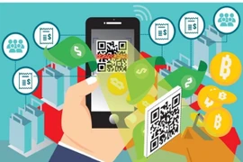 Multi-currency cards – a payment card supported by a mobile application that enables users to exchange local currency for foreign currency and make payments in stores or online - and mobile wallets for both daily and overseas spending will be popular in 2026. (Photo: courtesy of baochinhphu.vn)