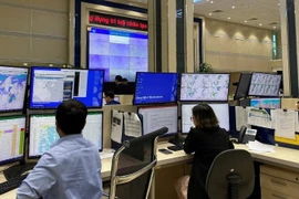 Forecasters analyse data on the smartmet system to serve the issuance of forecast bulletins and early warnings of natural disasters at the National Centre for Hydro-Meteorological Forecasting. (Photo: nhandan.vn)