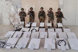 Soldiers stand next to Starlink machines as they seize KK Park online scam centre.