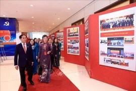 Deputy Prime Minister Bui Thanh Son and delegates visit the photo exhibition within the first Congress of the Government's Party Organisation on October 12. (Photo: VNA)