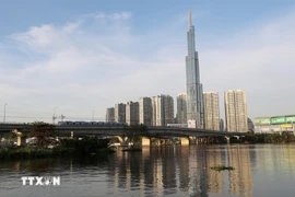 A train of Metro Line No. 1 passes Saigon Bridge in Ho Chi Minh City. (Photo: VNA)