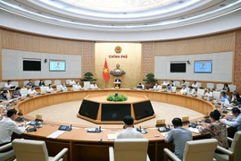 Prime Minister Pham Minh Chinh chairs a meeting of the Government Party Committee’s Standing Board and the Government on August 23 to review two months of implementing the two-tier local government model (Photo: VNA)