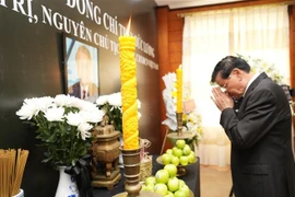 Party General Secretary and President of Laos Thongloun Sisoulith pays tribute to former State President Tran Duc Luong at the Vietnamese Embassy in Laos. (Photo: VNA)