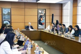 An overview of a group discussion on the draft Law on Artificial Intelligence (Photo: VNA)