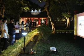 Visitors take part in a night tour at the Temple of Literature (Van Mieu – Quoc Tu Giam) in Hanoi. (Photo: nhandan.vn)