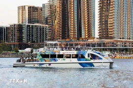 A cruise ship takes visitors tour Ho Chi Minh City on the Sai Gon River. (Photo: VNA)