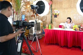 Behind the scene of a livestream session. Sellers from manufactures to distributors and retailers are pushing up livestreaming with hope to increase revenue as Tet (Lunar New Year) holidays are coming near. (Photo: VNA)