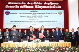 Representatives from Lao and Vietnamese agencies at the signing ceremony. (Photo: VNA)