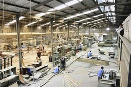 Producing interior-decor wooden furniture in HCM City (Photo: VNA)