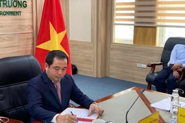 Acting Minister of Agriculture and Environment of Vietnam Tran Duc Thang signs the agreement (Photo: VNA)
