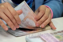 Thailand's Ministry of Finance is mulling amending tax laws on income from foreign investments to create a more favourable environment for investors and lure Thais to repatriate their earnings. (Photo: AFP/VNA)