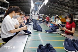 Workers produce footwear for export. (Photo: VNA)