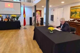 Mayor of The Hague Jan van Zanen, on behalf of the local authorities, ministries, sectors and the Government of the Netherlands, signs the condolence book and extends condolences to the State and people of Vietnam. (Photo: VNA)