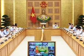 Prime Minister Pham Pham Chinh chairs the 15th online meeting of the National Steering Committee on combating IUU fishing connected with 21 coastal provinces and cities on September 30. (Photo: VNA)