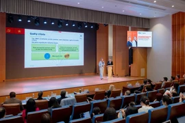 Experts from Germany’s FIBAA International Accreditation Organisation discuss international accreditation at an international conference held in HCM City on Tuesday. (Photo courtesy of UEH)