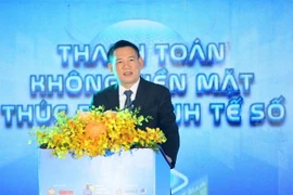 Deputy Prime Minister Ho Duc Phoc speaks on Saturday at a seminar held as part of the annual Cashless Day 2025 event in HCM City (Photo: VNA)