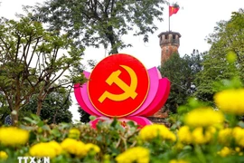 Flags, flowers, and banners adorn a street in Hanoi to welcome the 14th National Party Congress. (Photo: VNA)