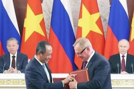 Representatives from Vietnam Airlines and Russia’s state-owned VTB Bank exchange the MOU on cooperation. (Photo: nhandan.vn)