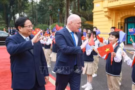 PM Pham Minh Chinh and his New Zealand counterpart Christopher Luxon are welcomed by Hanoi students. (Photo: VNA)