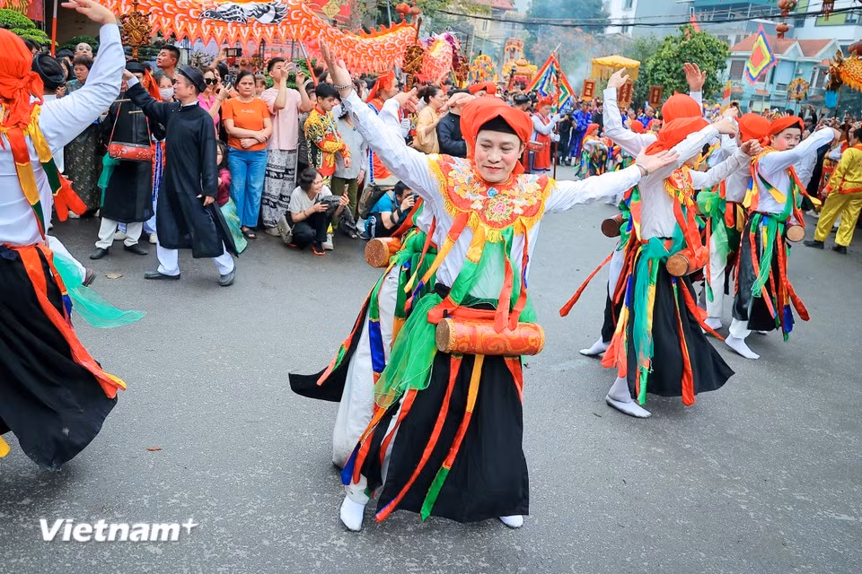 Wearing makeup and female costumes with drums strapped to their chests, performers execute lively and flirtatious dance movements together. (Photo: VietnamPlus)