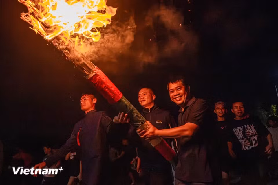 A giant torch, also known as a “dinh lieu,” is lit. Four giant torches symbolising the village’s four ancient gates are burned during the festival. The torches are shaped like upside-down fish traps, with large bamboo trunks soaked in mud and dried inside, and bamboo strips covering the outside. Each torch stands between 9 - 13 metres tall, with a top diameter of around 90 centimetres. (Photo: VietnamPlus)
