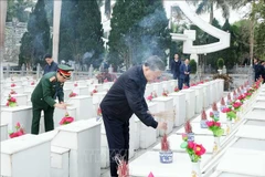 Party General Secretary To Lam offers incence at the graves of martyrs at the Vi Xuyen national martyrs’ cemetery. in Ha Giang province on February 5. (Photo: VNA) 