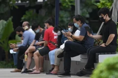 People using their mobile phones. (Photo: CNA/Calvin Oh)