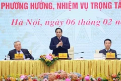 Prime Minister Pham Minh Chinh (standing) at the 10th nationwide online session of the National Committee for Digital Transformation in Hanoi on February 6. (Photo: VNA)