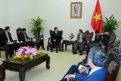 Deputy Prime Minister Tran Hong Ha (R) and Tan Wangen, Director of Commercial Aircraft Corporation of China, Ltd. (COMAC), in Hanoi on January 15. (Photo: VNA)