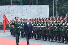 Party General Secretary To Lam (right), who is also Secretary of the Central Military Commission, review the guard of honour during his working visit to Military Region 7 on January 8. (Photo: VNA)