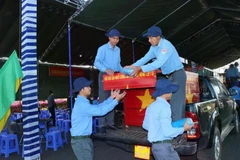 At a ceremony held in Binh Phuoc province on January 10 to receive the remains of 41 martyrs who fell down during wartime in Cambodia. (Photo: VNA)