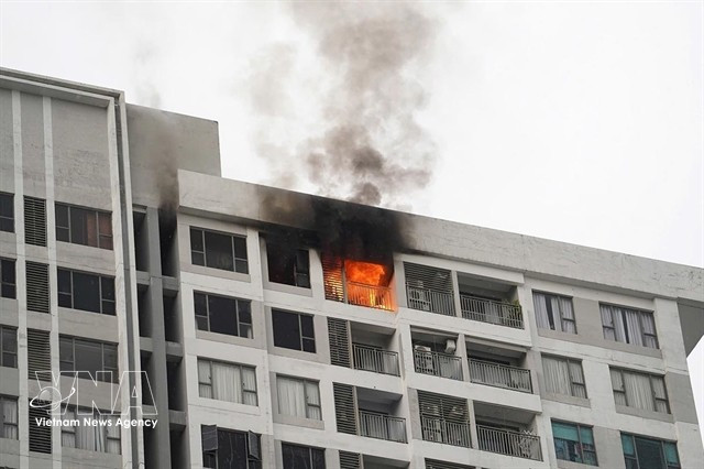Smoke and flames rise from an apartment building in Ho Chi Minh City in late 2025. (Photo: VNA)