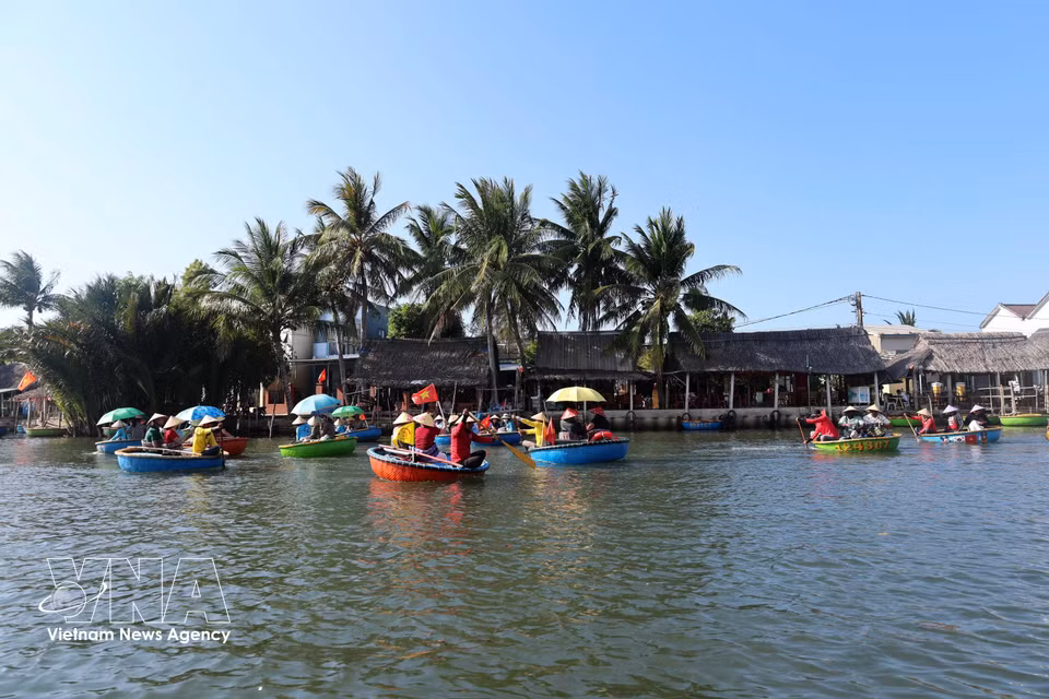 Visitors drift along on small basket boats to explore Cam Thanh coconut village, named among the world’s 50 most beautiful villages in 2025. (Photo: VNA)