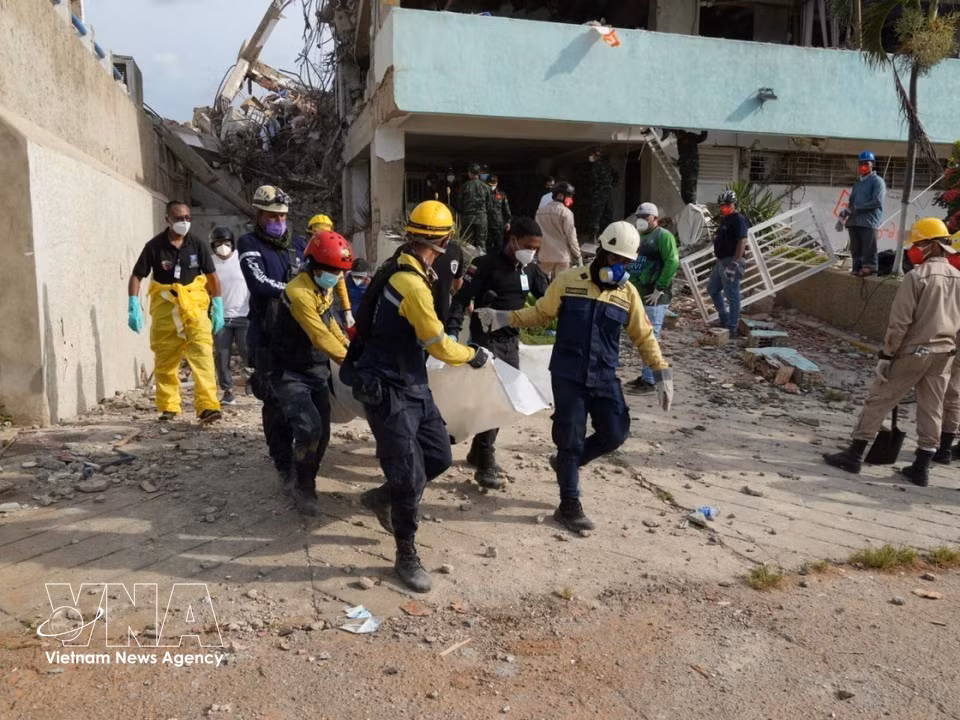 The bodies of victims are recovered from the rubble and handed over to Venezuelan authorities. (Photo: VNA)