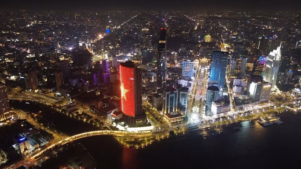 An aerial view of Ho Chi Minh City by the Saigon river with illuminated skysrappers. (Photo: VNA)