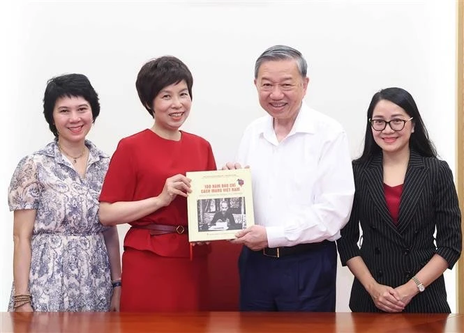 General Director of the Vietnam News Agency (VNA) Vu Viet Trang (second from left) presents the photo book to Party General Secretary To Lam. (Photo: VNA)