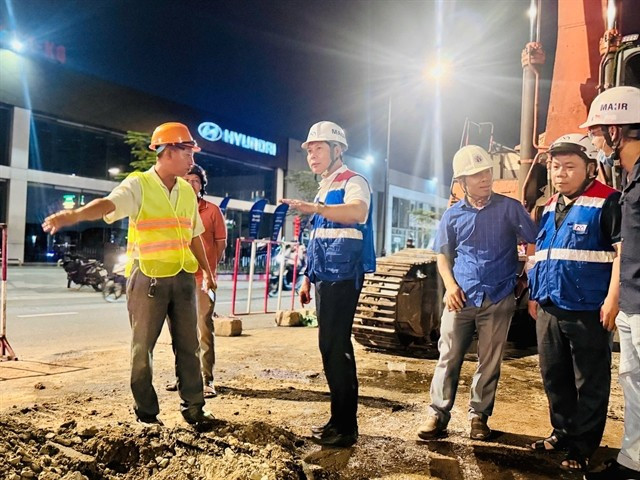 Phan Cong Bang, Director of the city’s Urban Railway Management Board (second from left), oversees work at the construction site. (Photo: nguoiduatin.vn)