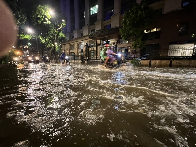 Prolonged heavy rain causes flooding on Tong Dan street in Hoan Kiem district of Hanoi. (Photo: VNA) 