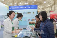 Visitors experience a diverse range of products at the TH Group's booth (Photo: VNA)