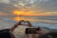Tourists enjoy the sunrise moment in Mui Ne. (Photo: VNA)