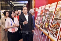 NA Chairman Tran Thanh Man checks photo display for the award ceremony (Photo: VNA)