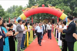 Politburo member and permanent member of the Party Central Committee’s Secretariat Tran Cam Tu (C) attends the great national unity festival in Thac Ba commune. (Photo: VNA)