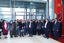 Politburo member and Standing member of the Party Central Committee’s Secretariat Tran Cam Tu (C) inspects preparations for the upcoming 14th National Party Congress at the National Convention Centre. (Photo: VNA)