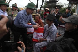 Deputy Prime Minister Le Thanh Long presents gifts to residents in Luat Le village, Gia Lai province. (Photo: VNA)