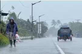 A man walks along a road amid heavy rain due to weather patterns from Super Typhoon Ragasa in Lal-lo town, Cagayan province on Sep 22, 2025. (Photo: AFP)