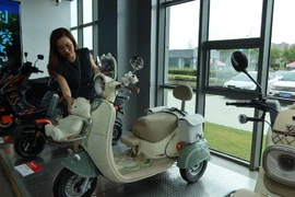 With attractive and user-friendly designs, electric motorbikes are more popular, contributing to environmentally sensitive transport modes. (Photo: VietnamPlus)
